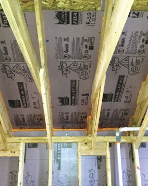 For a slight boost in R-value and to create a vent space that won’t be crushed by the pressure of dense-blown cellulose, the author’s company installs a custom insulation baffle in cathedral-roof rafter bays and scissors-truss bays.