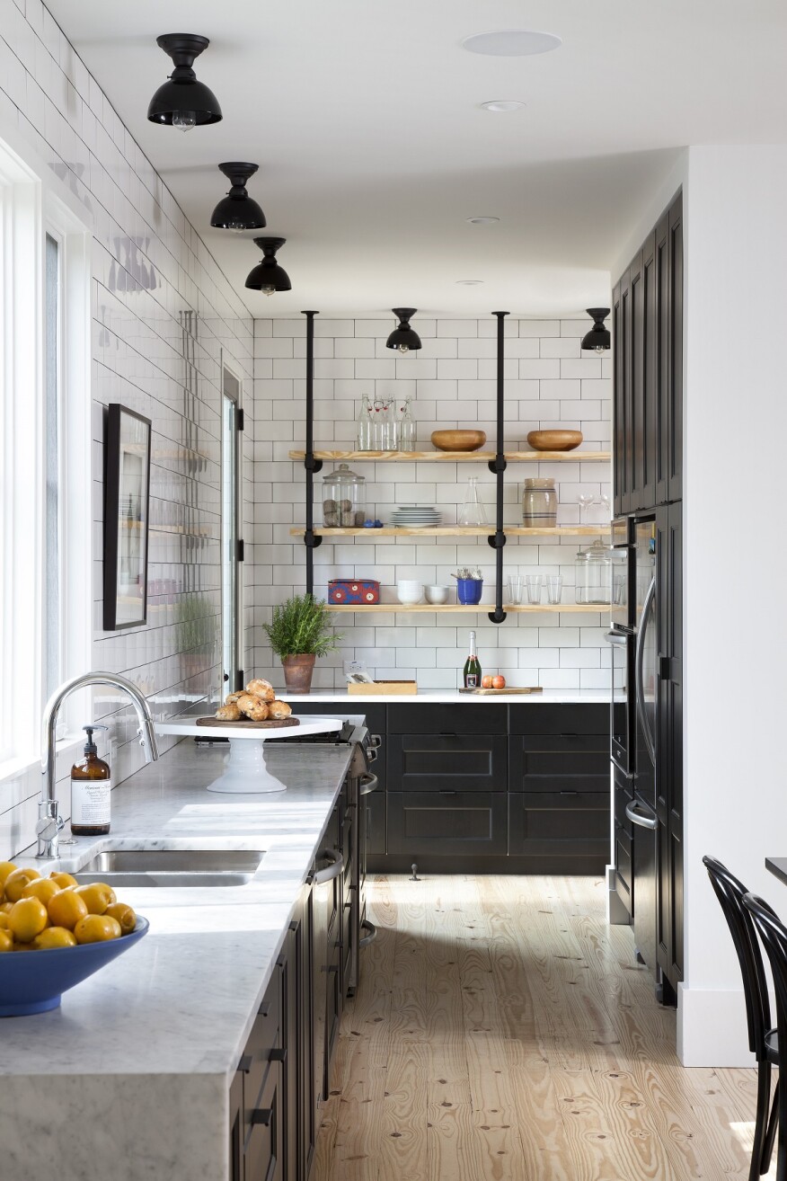 The simple installation of shelves provides additional
storage for homeowners in a way that leaves this smaller kitchen feeling spacious.
Project: Clifford Residence by Texas Construction Company 