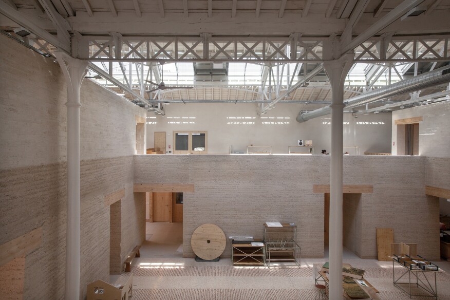 Rammed-earth and CEB block walls inside Le Magasin Électrique.