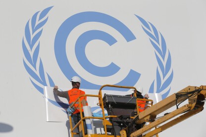 Workers install a logo on the facade of the U.N Climate Conference in Le Bourget, outside Paris.
