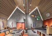 The building is clad with fibre cement sheets of varying shades of red