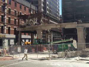 Crews demolish the landmark Filenes building in downtown Boston in August, 2013, to prepare the site for a $630 million commercial development. Construction in the city is accelerating, boosted by a hot local economy and supportive city policies.