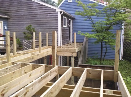 Tacking guard posts in place as the deck is framed ...