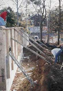 Excavation made it difficult to install counter bracing on the exterior side of the wall. However, it proved to be essential to countering the tendency of the perimeter forms to bulge outward during the pour. Screw-jack adjustments at the base of the braces pushed the forms back into position.