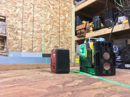 Here, the green laser level is side by side with a comparable red laser level in a fully lit workshop.