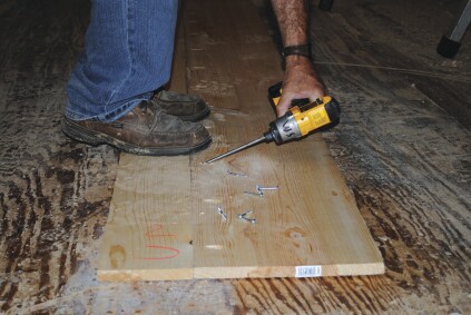 If wider boards are needed for bigger box beams, two boards can be edge-glued and pocket screwed together. Standing on the boards aligns the edges where clamps can't reach.