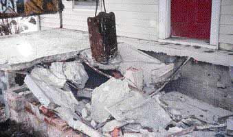 To avoid the risk of running a jackhammer on an elevated slab, the excavation sub used an improvised ram to break up the concrete. When the slab and foundation were gone, the smaller pieces close to the house were removed with a sledgehammer.