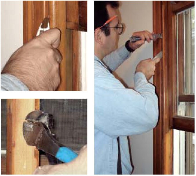 After scoring the joints with a sharp utility knife, the author inserts a putty knife and a thin pry bar between the interior stop and the jamb, then carefully pries away the stop. Since these stops will be reinstalled later, they have to be removed carefully.