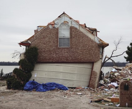 In what has become a classic failure mode, the upper corners of this garage have rotated, unable to withstand the lateral force of strong winds (note the bad location of the panel joint at the upper right hand corner).