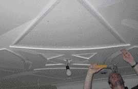On another job, the author applies vinyl bead to an abstract pattern on the ceiling.