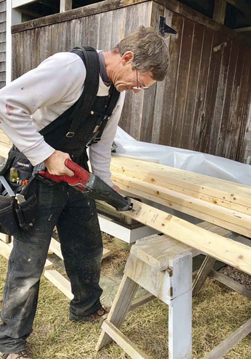 A narrow blade in a recip saw makes it easy to cut out a curved notch in a stud.