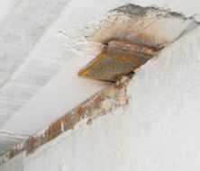 Where the planks bear on the foundation walls, steel plates cast into both the planks and the foundation are welded together.