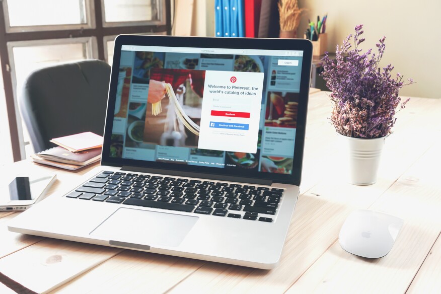 Laptop displaying social Internet service Pinterest on the screen. Is an online pinboard that allows people to pin their interesting things.