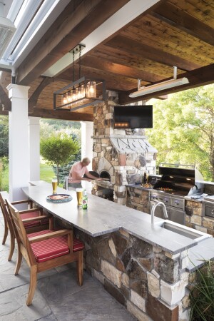 Outdoor Escape: Built for a transplanted California chef in Maple Plain, Minn., this covered outdoor kitchen by Mom&#39;s Design Build boasts several serious kitchen features, including a wood-fired pizza oven, grill, side burners, sink, fridge, and taps for beer and root beer. 