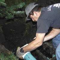 The concrete distribution box divides the effluent equally among the three trenches, so it has to be level.
