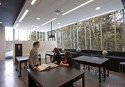 Environmental studies students and their professor in the lab. The large windows provide views into the campus's Arboretum. 