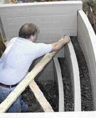 The manufacturer requires that the ScapeWel be backfilled with gravel; this reduces soil pressure that could distort the molded plastic. Prior to backfilling, the unit must be braced with 2x4s or 2x6s to prevent distortion.