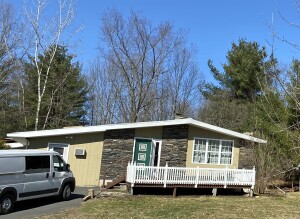 The author was in for an unwelcome surprise when he set out to replace the roof on this single-family home with a shallow pitched roof.