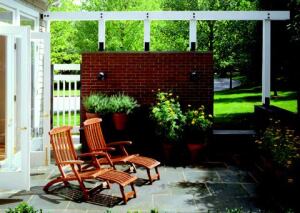 This compact terrace sits on the southeast side of the house where it basks in the morning sun. A floating brick wall blocks views of the driveway.