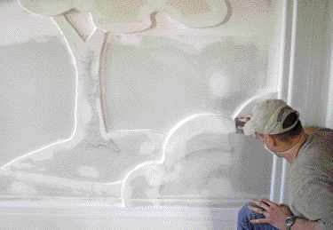 Sanding is more difficult. Here, the author uses a sanding sponge to smooth near an edge.
