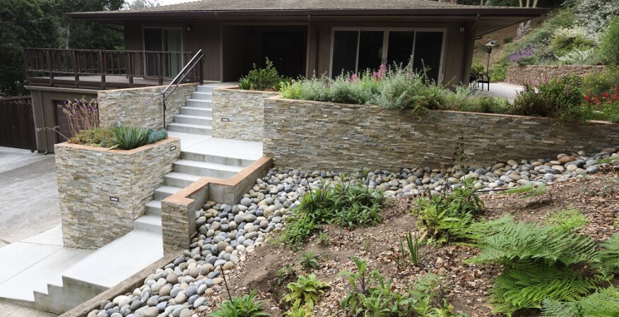 In addition to offering a no-maintenance stone paver surface, the new deck features wider stairs and landings for easier access, more outdoor living area, and improved drainage on the sloped site.