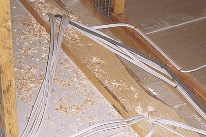 Top plates of partition walls in attics are huge sources of air leaks, made worse by all the electrical penetrations.