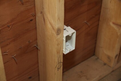 Small plastic nubs on the sides of the electrical box sets it at the proper depth for the drywall.