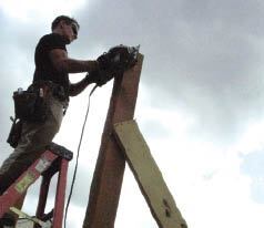 After double-checking the posts’ final height, the author tops them off using an 8 1/4-inch circular saw. Two passes with the big saw cuts completely through 6x6 stock.