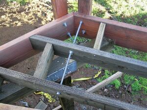 Reinforcing the post with threaded rod adds stability. The washers and nuts on both sides of the framing members that the rod passes through make it possible to plumb up the posts perfectly.