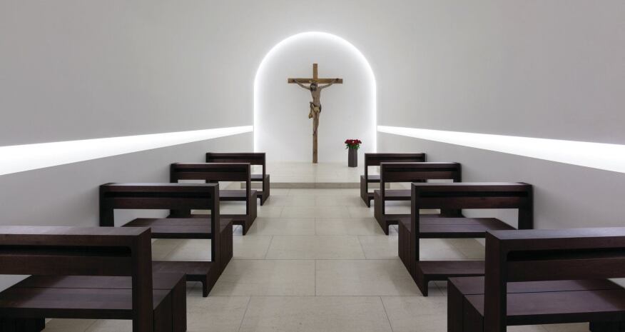 The Sacramental Chapel illumination features two horizontal light slots, which lead to a covelit arch at the front of the chapel and a crucified figure of Jesus.