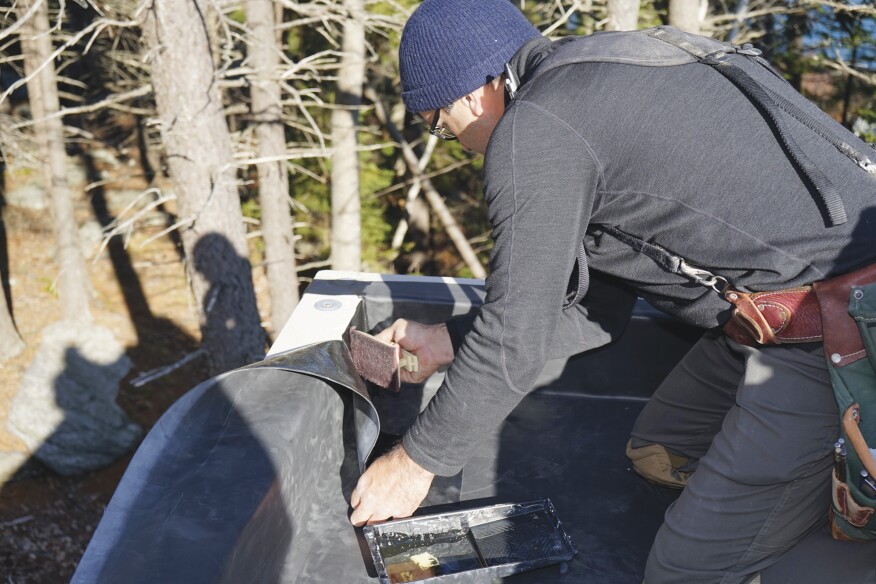 Detailing the parapet corners is a tricky process best learned from Firestone’s YouTube videos. Here, the author cleaned and primed the EPDM before executing his corner fold.