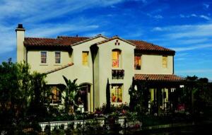FAMILY-FRIENDLY: The Spanish elevation of the bestselling Plan 2 has everything that families want, including five bedrooms and a loft, three and a half baths, a two-car garage plus tandem storage space, and a dramatic vaulted ceiling in the family room that adds flair to a well-used space.