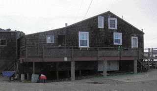 Creosote-treated wood piles supported the cottage 5 feet above the beach, so storm surge could flow under it. The decks were carried by shallow concrete piers.