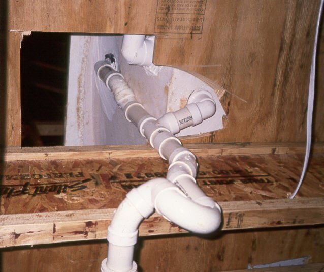 Gaping holes are often left under tubs, allowing huge amounts of air infiltration from the crawlspace below.