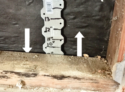 On the inside of the wall (above), a steel strap easily slides behind the plate, past the weep screed to daylight. There was no way from the exterior to shut down the massive air leak, so the approach was to attempt to slow it down from the interior.