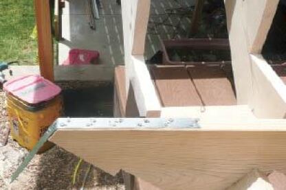 Figure 1. The stair jack, or stringer (foreground, upside down), is cut to extend below the joists. Galvanized-steel strapping is nailed to the jack’s bottom with 10d commons.