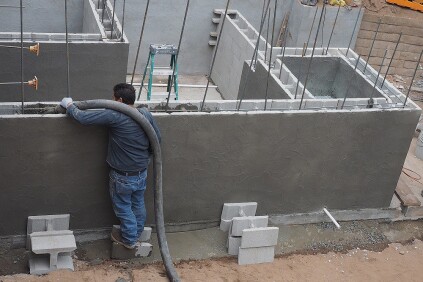 The planter walls were built with masonry blocks that were held together with surfacing bonding cement (SBC) rather than mortar. The walls were reinforced with rebar, then filled with concrete.