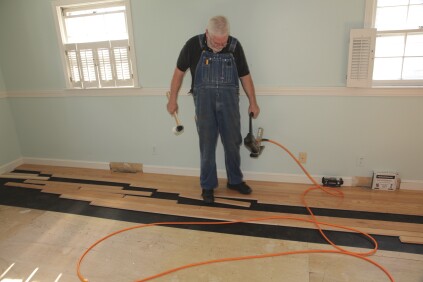 An installer's feet get as much of a workout as the arms. Soft-soled shoes are a must! The first step is pulling the next board over from the "rack."