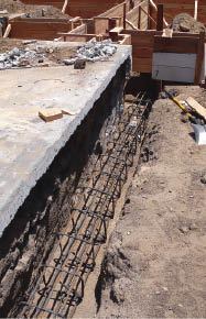 To carry exterior wall loads, perimeter grade beams require #5 rebar cages and a 3,000-psi concrete mix.