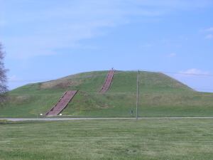 Monk's Mound, created by the Mississippian culture, is located at Cahokia. The staircase you see is new, but built to follow the course of the original wooden stairs. Also visible is a road and power lines cutting through the site.