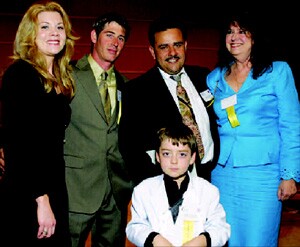 Urbieta Construction received the Better Business Bureau's 2005 International Torch Award. At the ceremony (from left to right): Amanda Spurrier; Phillip Spurrier, a lead carpenter at Urbieta Construction; owners Juan Urbieta and Carmen Guerrero-Urbieta; and the Urbieta's 10-year-old son, Angel.