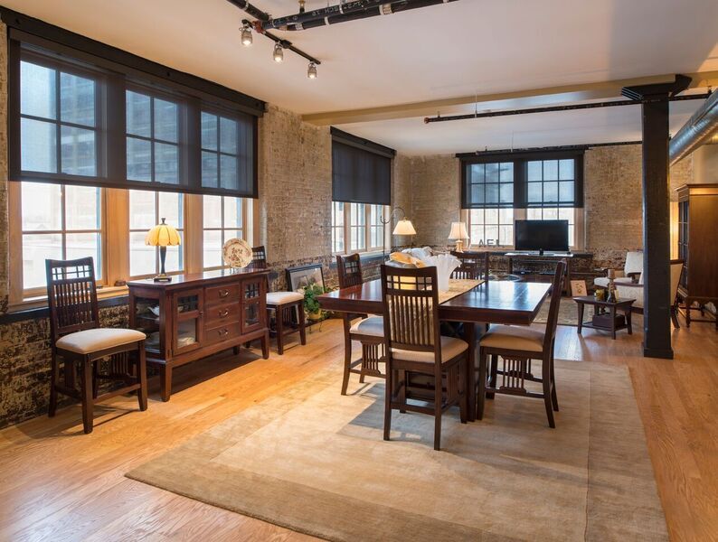 A clubroom at 500 Seneca hints at the building's warehouse, turn-of-the-20th-century past, with its exposed-brick walls and Craftsman decor.