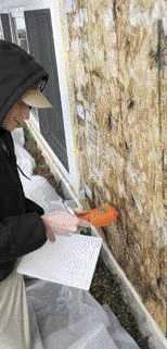 The author's crew used a hand-held moisture meter to mea-sure the moisture levels in the OSB-covered SIPs panels. Readings were highest around windows — which had been poorly flashed — and closer to grade, where water leaking in from above would have accumulated.