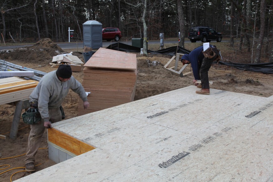 After marking the measurements to locate the the front walls of the house, the crew snaps those lines.