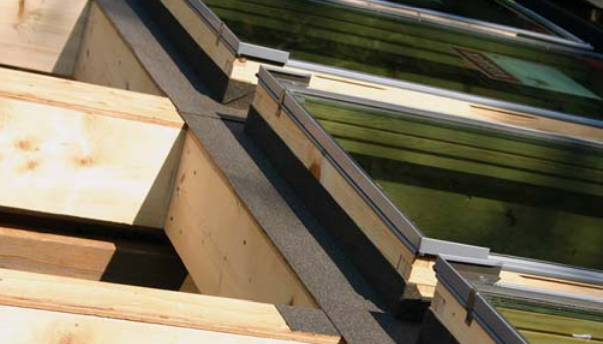 U-shaped and L-shaped pieces of self-sticking roofing membrane seal the transition between roof and frame.