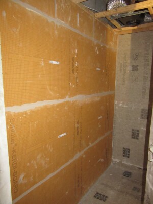 Here, insulated Kerdi Board is installed on an exterior wall, keeping the shower side warmer and providing a more comfortable bathing experience.