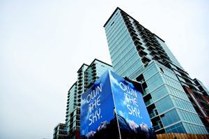 FIRST GLANCE: An imposing billboard, with the tagline "Own the Sky," was the only visible advetising the developers of Glass House used to promote their building.  That signage directed people to the project's Web site, where they could register to receive more information.