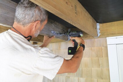 Then fasten the tie to the joist.