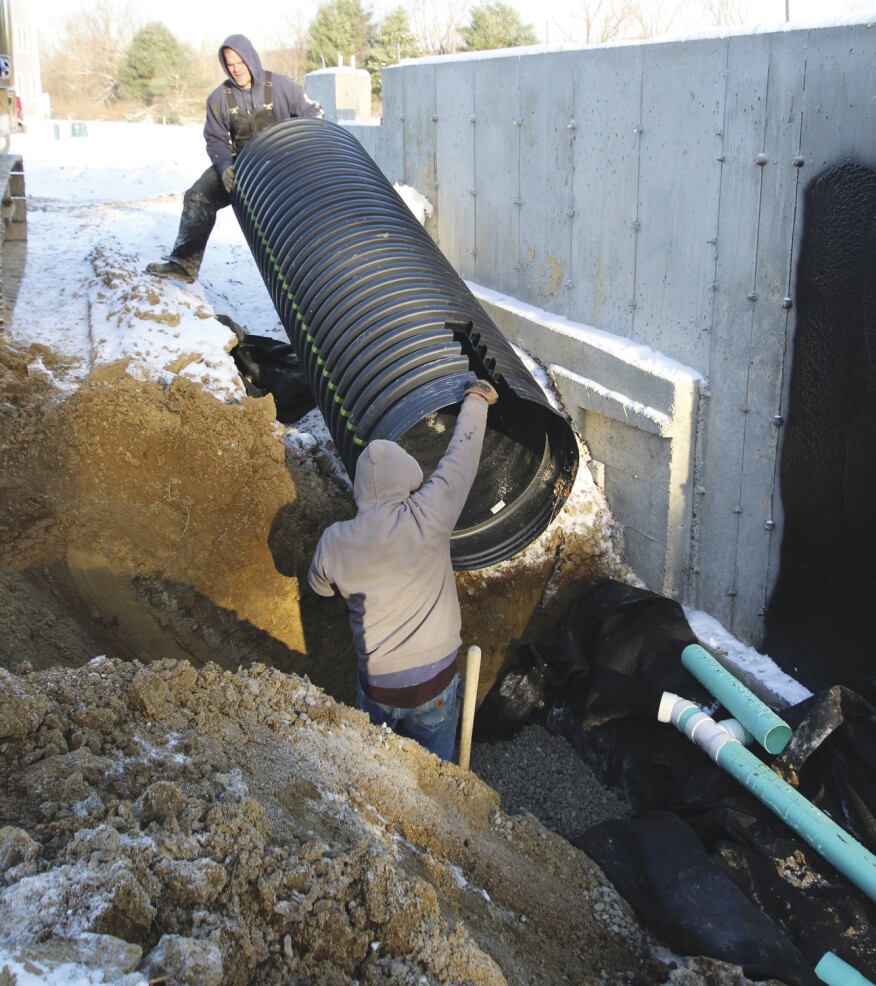 The culvert is muscled into place.