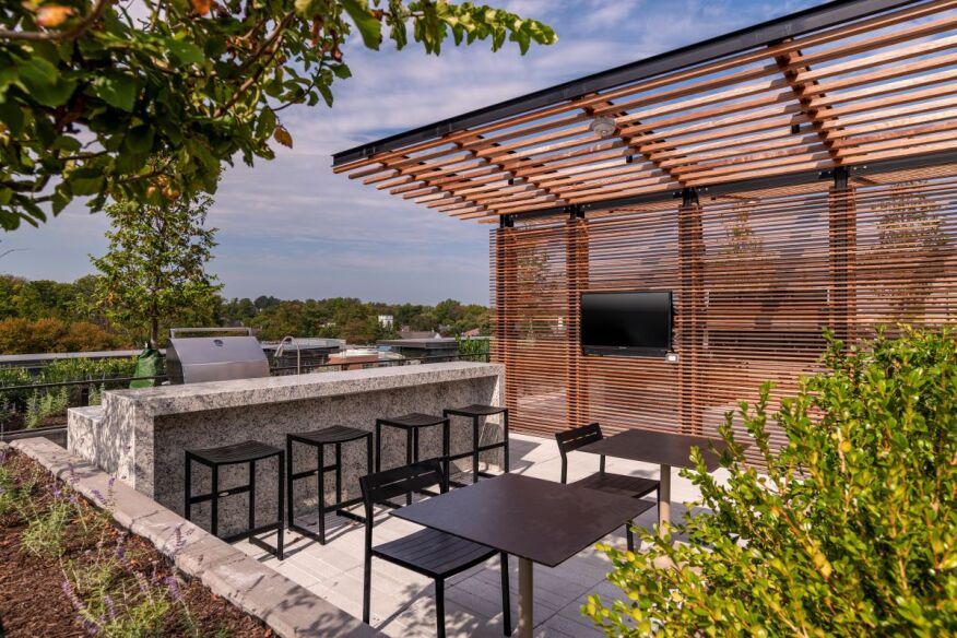 Near the rooftop pool at Maizon Bethesda residents have access to grilling stations with outdoor TVs.